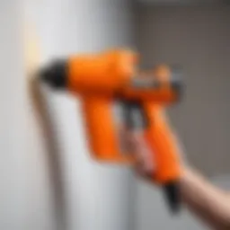 Spray foam gun in use with foam material